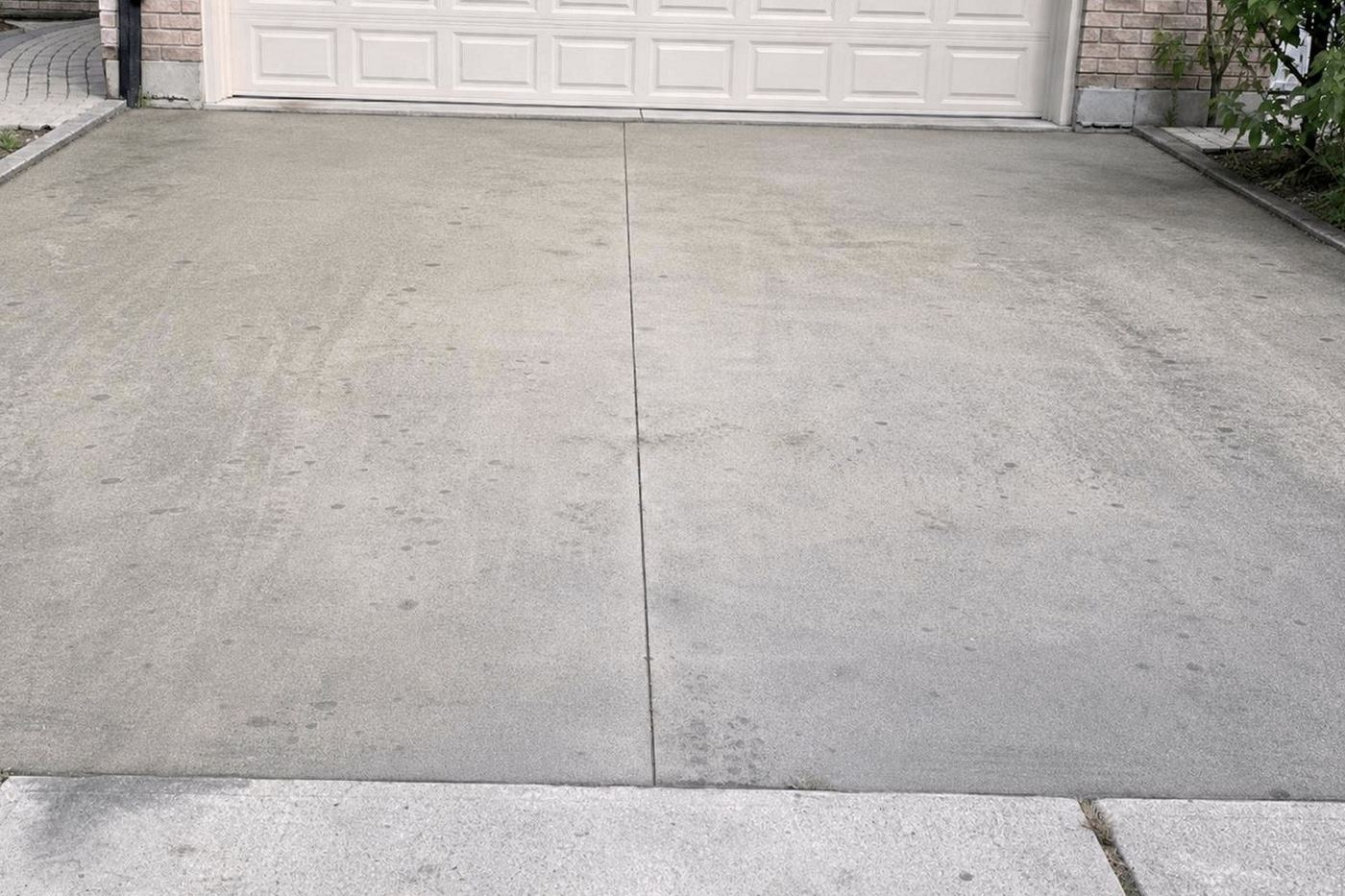 The same concrete pad restored to bright light grey